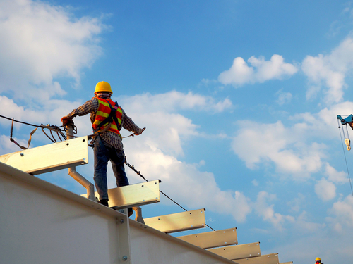 Construction Worker on top of roof