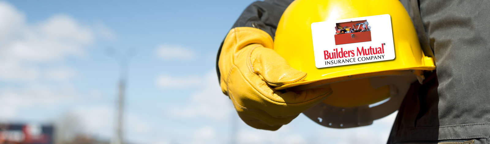 Construction worker holding hardhat