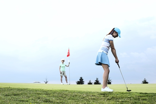 Women golfers warming up