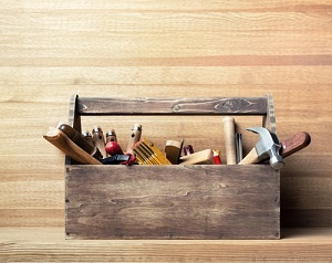 Filled toolbox on wood background.